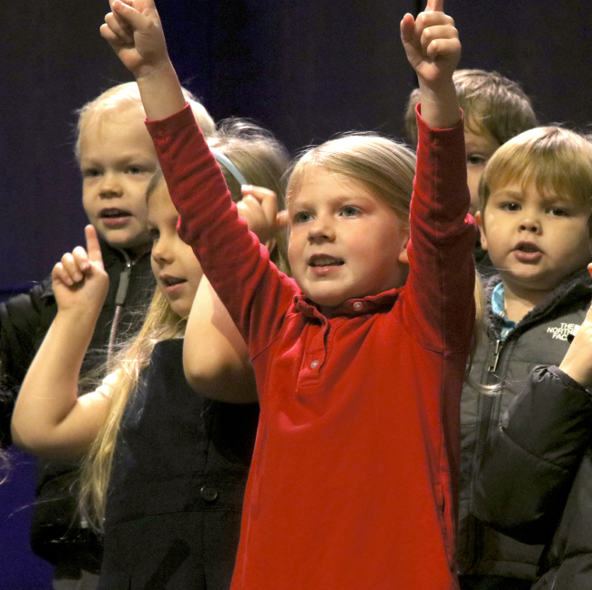 Kindergarten children in a group singing