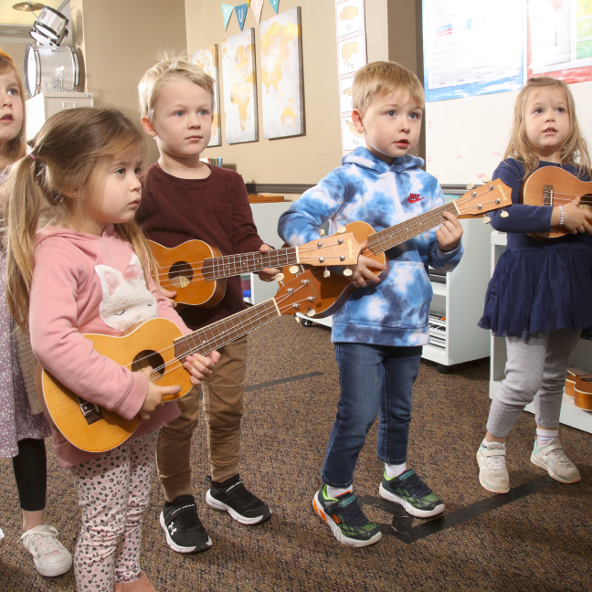 small children with guitars singing